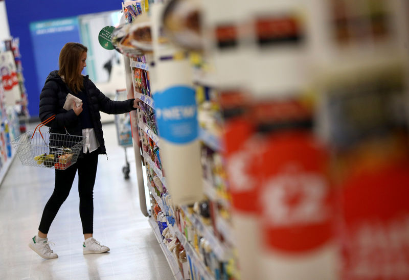 © Reuters. FILE PHOTO -  A woman shops at a Sainsbury's store in London