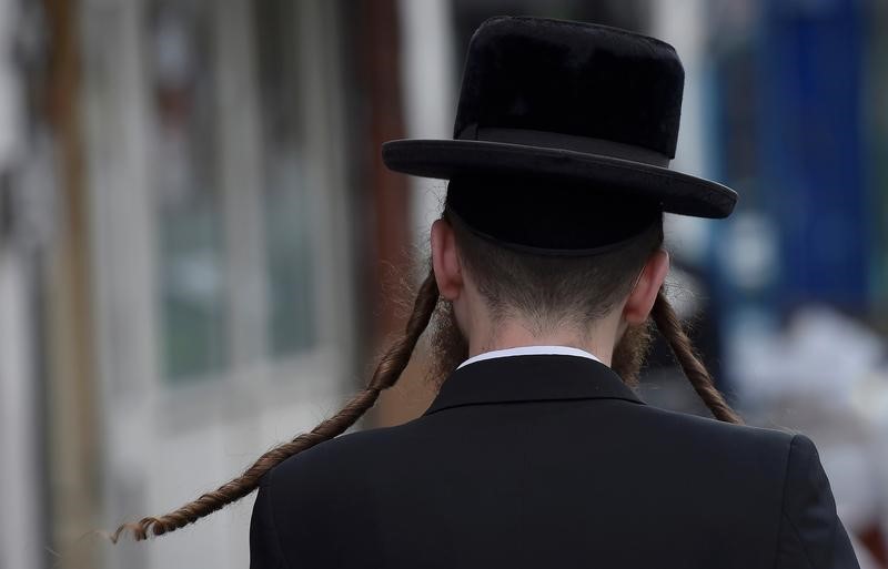 © Reuters. An orthodox Jewish man walks through a street in Stamford Hill north London