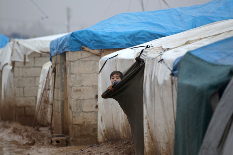 © Reuters. An internally displaced Syrian boy looks out his tent in the Bab Al-Salam refugee camp, near the Syrian-Turkish border