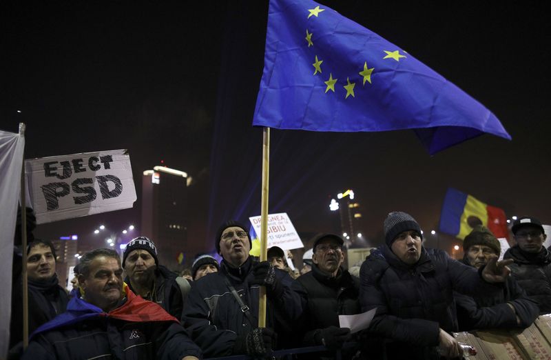 © Reuters. Protesters hold EU flag during a demonstration in Bucharest