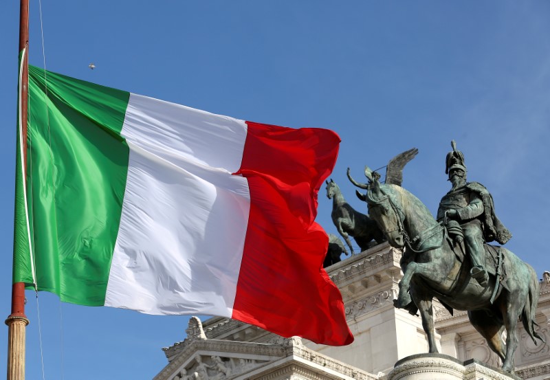 © Reuters. The Italian flag waves in front of The 