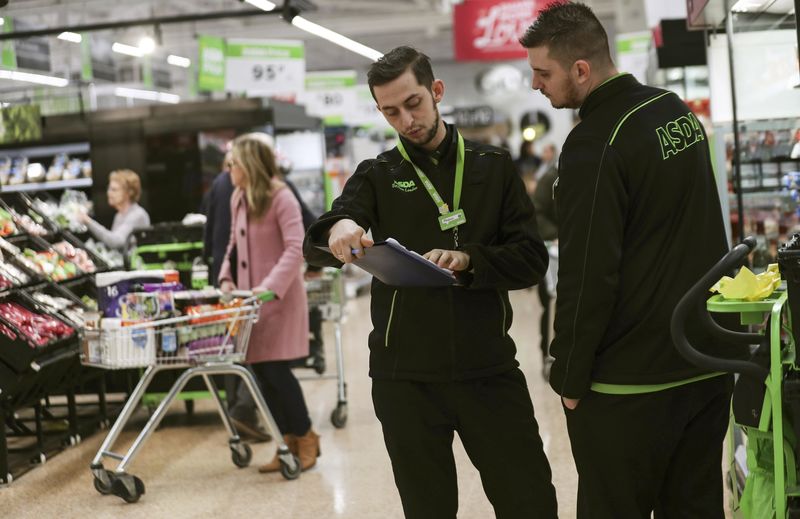 © Reuters. Employees check stock at the Asda superstore in High Wycombe