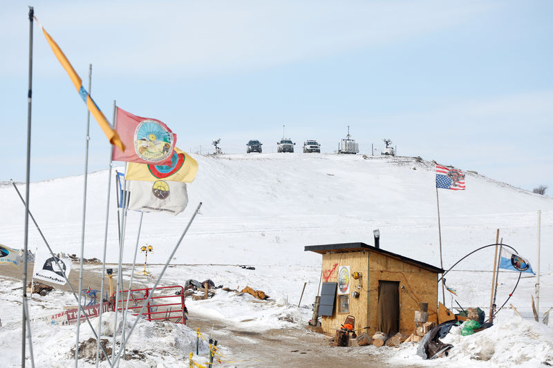 © Reuters. Police vehicles idle on the outskirts of the opposition camp against the Dakota Access oil pipeline near Cannon Ball