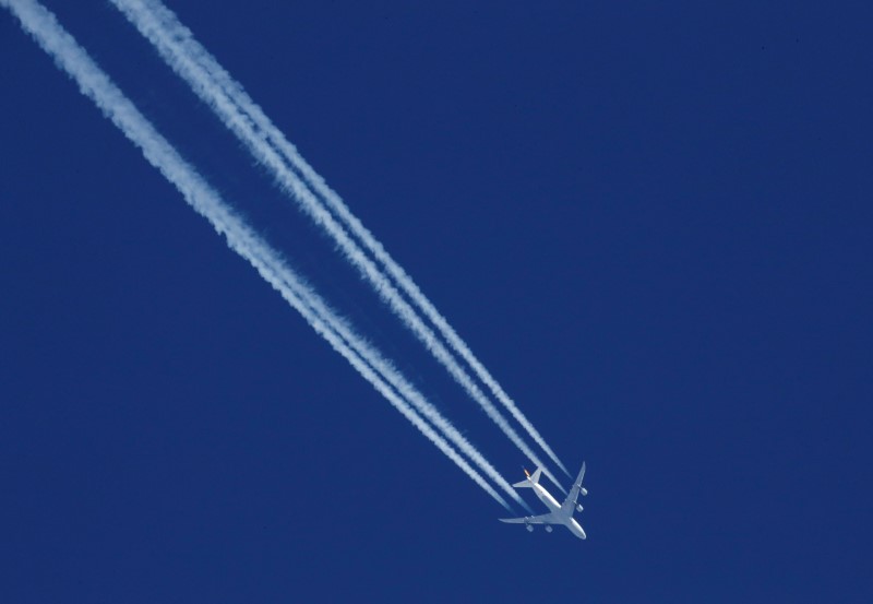 © Reuters. Contrails from a Lufthansa plane are seen in the sky over the ski resort of Val d'Isere