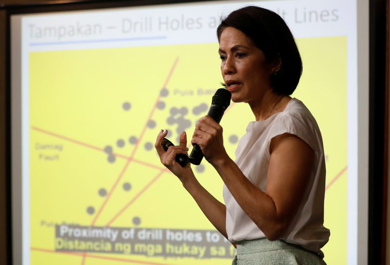 © Reuters. Lopez speaks in front of a chart on mining issues during a press briefing in Manila