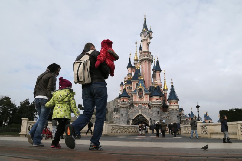 © Reuters. Visitors walk towards the Sleeping Beauty Castle during a visit to the Disneyland Paris Resort in Marne-la-Vallee