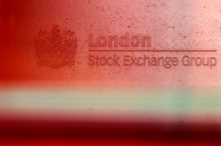 © Reuters. A red London bus passes the Stock Exchange in London
