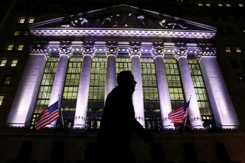 © Reuters. A commuter passes by the NYSE in the financial district in New York