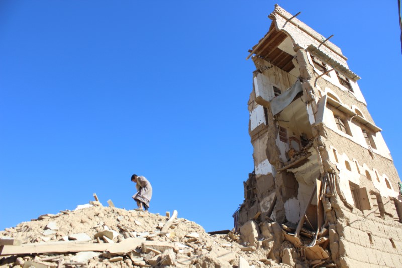 © Reuters. Boy walks on the rubble of a house destroyed by a recent Saudi-led air strike in the northwestern city of Saada, Yemen