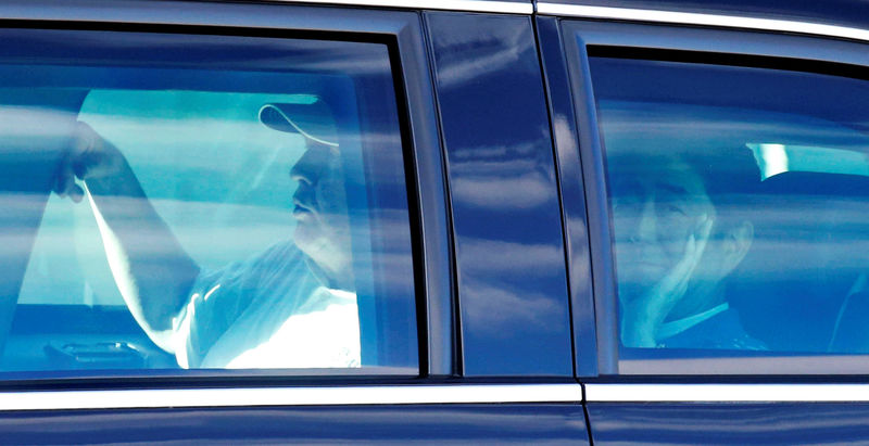 © Reuters. Japanese Prime Minister Abe and U.S. President Trump are seen in the Presidential Limousine as they depart from Trump International Golf club in West Palm Beach, Florida