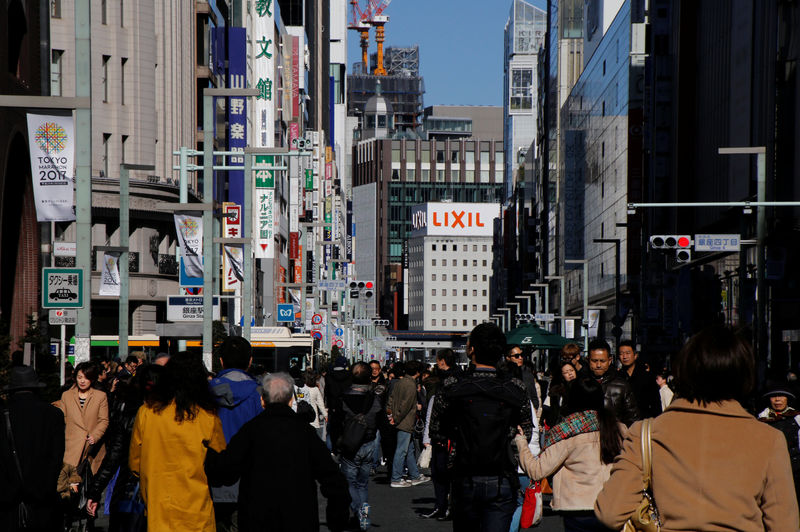 © Reuters. People walk on a street at Tokyo's Ginza shopping district