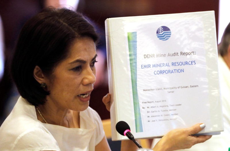 © Reuters. Philippine Environment and Natural Resources Secretary Regina Lopez shows a mining audit report of a mine that she ordered closed during a meeting in Manila