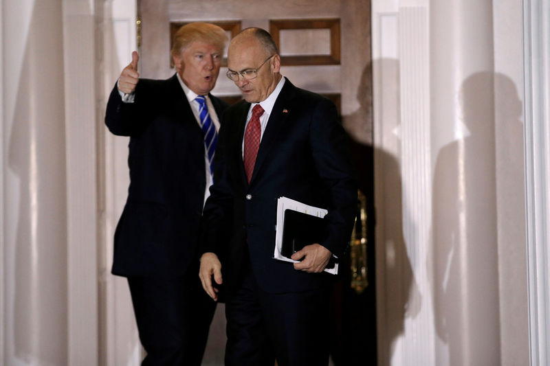 © Reuters. FILE PHOTO - Donald Trump gestures as Andy Puzder departs after their meeting at the main clubhouse at Trump National Golf Club in Bedminster