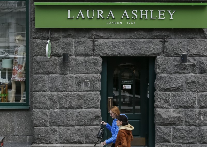 © Reuters. People walk past Laura Ashley store in Kiev