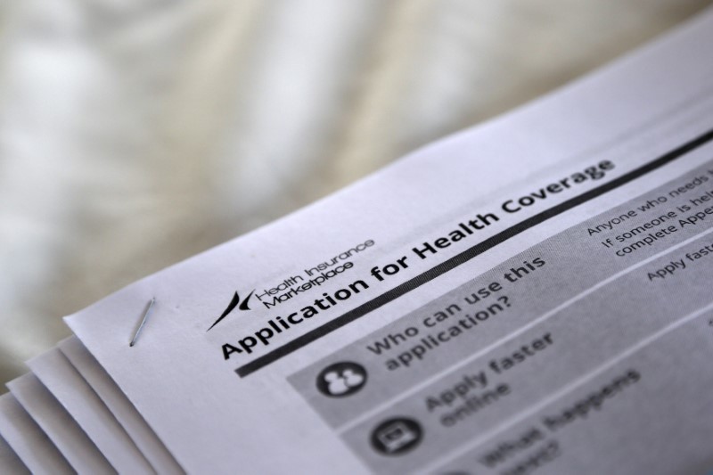 © Reuters. FILE PHOTO - Applications are seen at a rally held by supporters of the Affordable Care Act in Jackson Mississippi