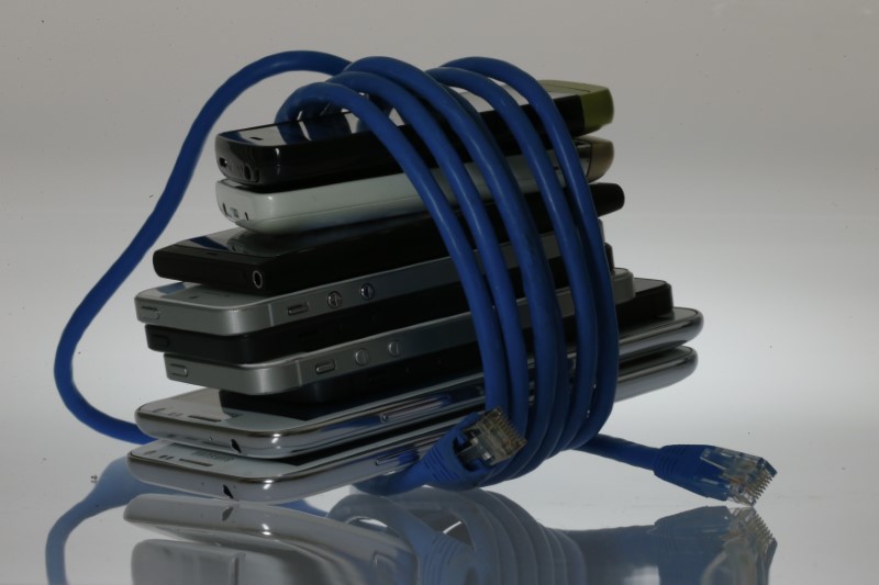 © Reuters. An illustration picture shows a network cable wrapped around to a pack of smartphones in Berlin