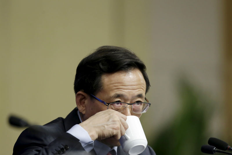 © Reuters. Liu Shiyu, chairman of the China Securities Regulatory Commission, drinks tea at a news conference in Beijing