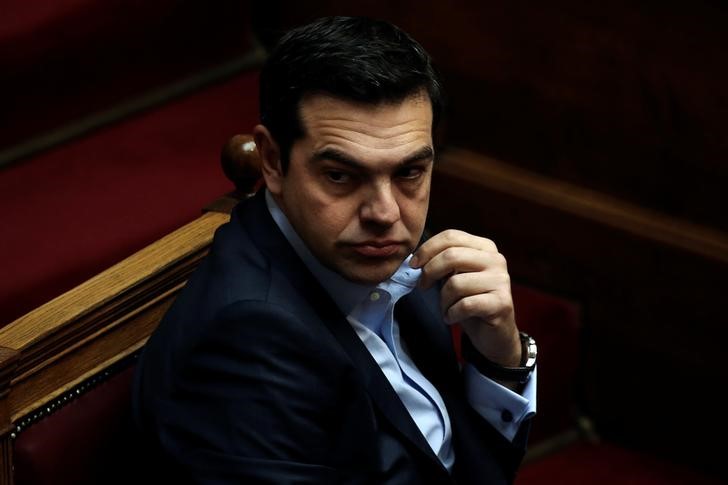 © Reuters. Greek PM Tsipras looks on before answering a question on corruption, during the PM's Question Time at the parliament in Athens