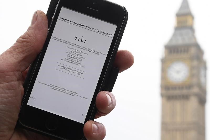 © Reuters. A man poses with an electronic copy of the Brexit Article 50  bill, introduced by the government to seek parliamentary approval to start the process of leaving the European Union, in London
