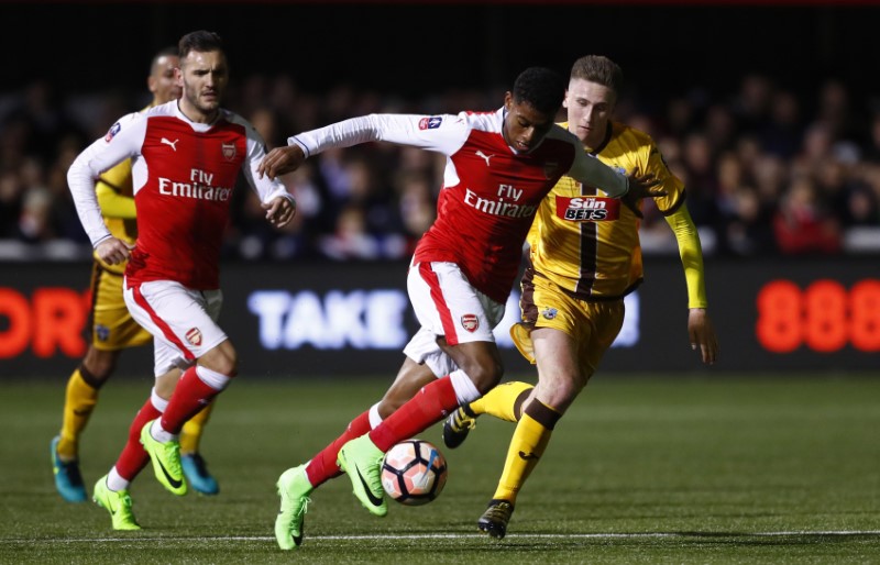 © Reuters. Arsenal's Jeff Reine-Adelaide in action with Sutton United's Adam May