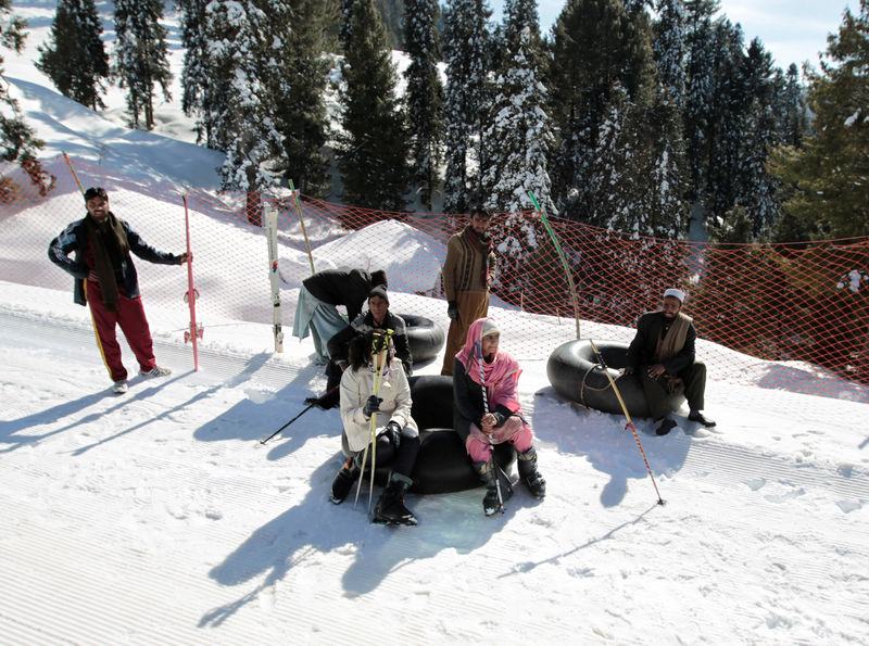 © Reuters. Customers and inner tube renters rest on the side of the piste at the ski resort in Malam Jabba