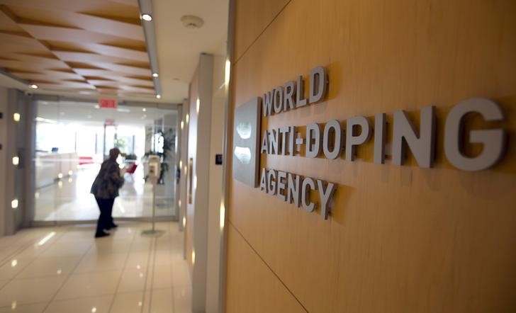 © Reuters. A woman walks into the head offices of WADA in Montreal