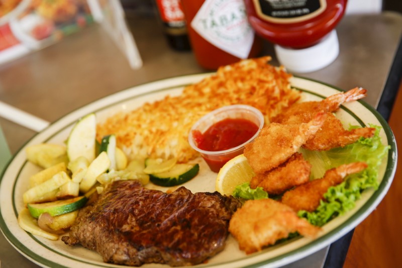 © Reuters. A steak and fried shrimp combo plate is served to a customer at Norms Diner on La Cienega Boulevard in Los Angeles, California