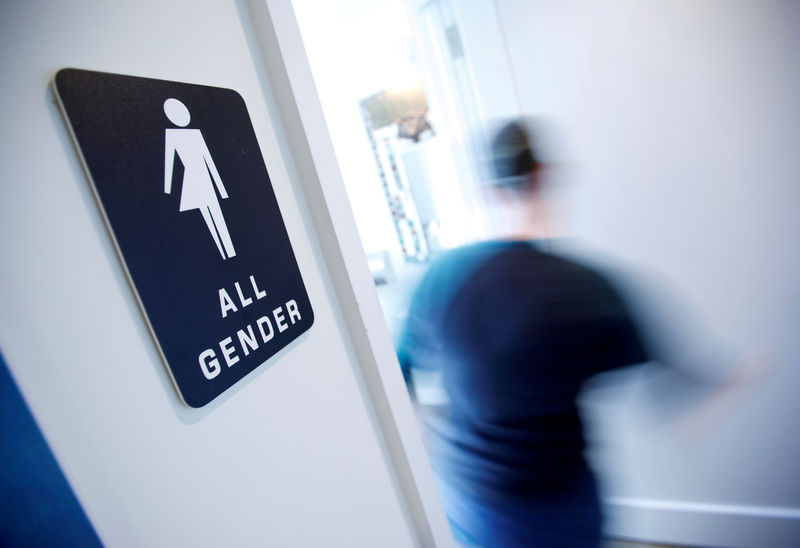 © Reuters. FILE PHOTO - A bathroom sign welcomes both genders at the Cacao Cinnamon coffee shop in Durham North Carolina