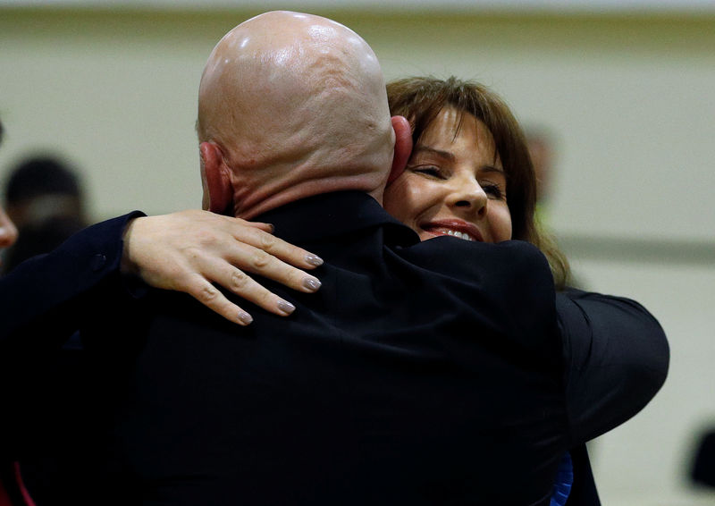 © Reuters. Conservative Party candidate Trudy Harrison embraces her husband Keith after winning the Copeland by-election in Whitehaven