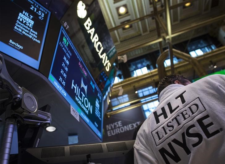 © Reuters. A trader wears a Hilton robe during the company's IPO at the New York Stock Exchange