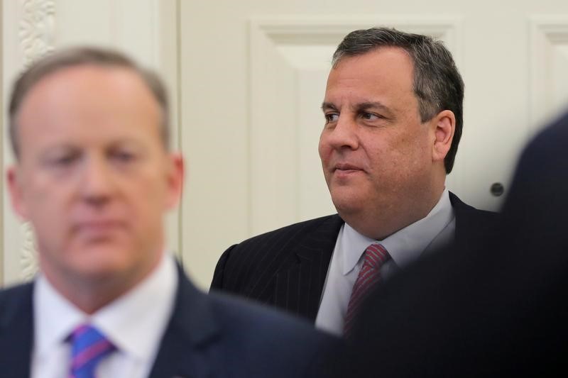 © Reuters. Governor of New Jersey Christie stands next to White House Press Secretary Spicer as U.S. President Trump signs H.J.Res. 41 at the Oval Office of the White House in Washington