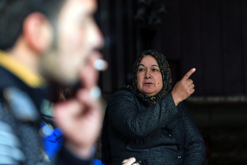 © Reuters. A woman whose son says he is fighting alongside Islamic State militants, speaks during an interview at her home in Qayyara