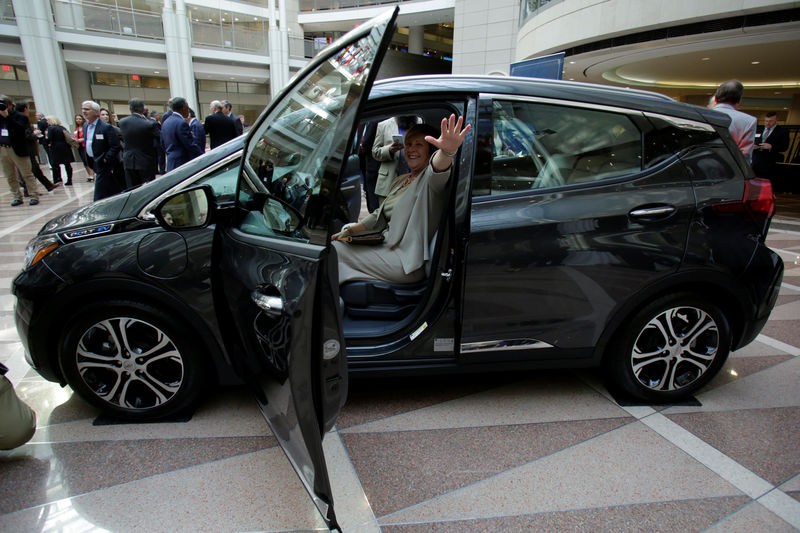 © Reuters. A woman sits inside the 2017 Chevrolet Bolt EV, on display during The Economic Club event in Washington