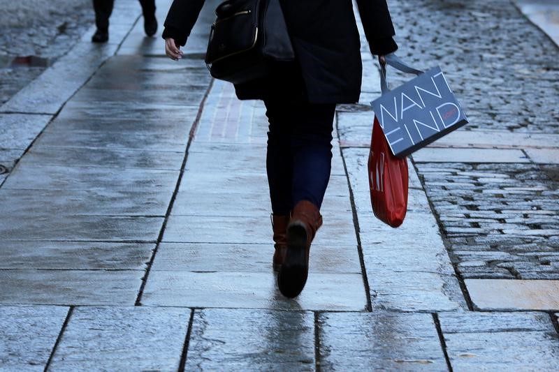 © Reuters. A shoppers carries bags with purchases through Quincy Market in downtown in Boston