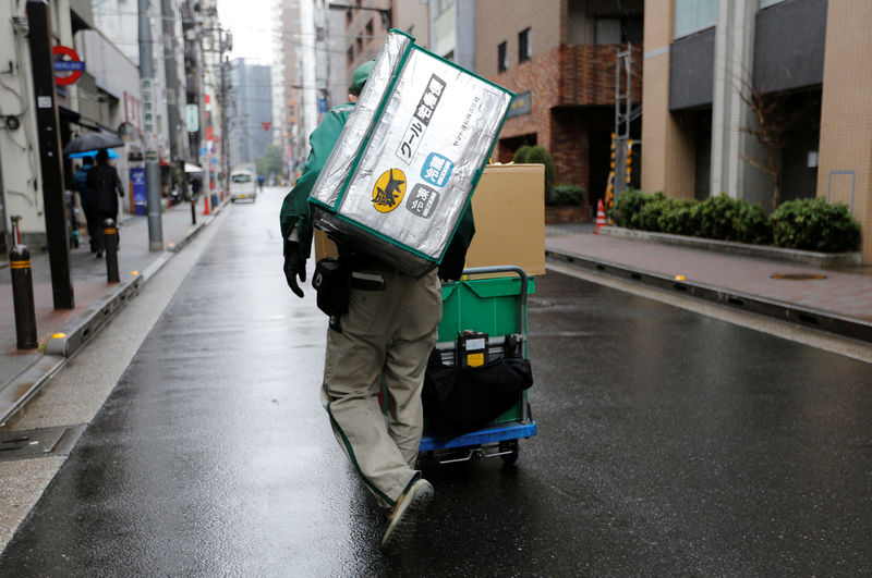 © Reuters. Deliverer of Yamato Transport Co is seen at a business district in Tokyo