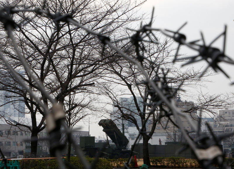 © Reuters. A unit of Patriot Advanced Capability-3 (PAC-3) missiles is behind a barbed wire fence at the Defense Ministry in Tokyo