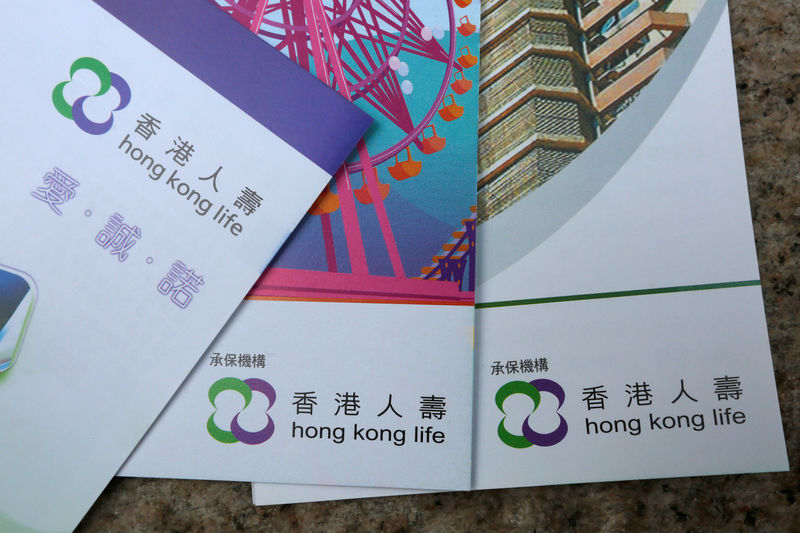 © Reuters. FILE PHOTO - Leaflets on various plans provided by Hong Kong Life Insurance are displayed in this illustration photo