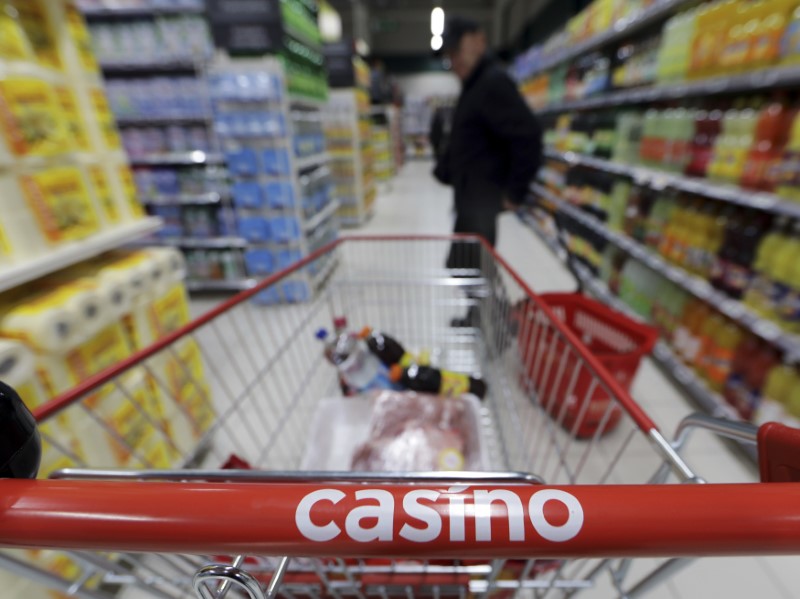 © Reuters. A customer stands in an aisle near a shopping trolley in a Casino supermarket in Nice