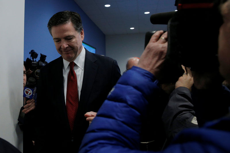 © Reuters. FBI Director James Comey walks past reporters and news cameras without comment after a ceremony to open the new FBI Boston Field Office in Chelsea