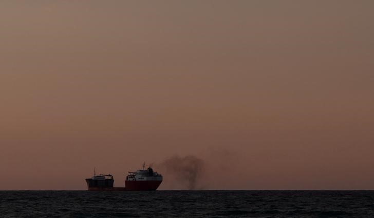 © Reuters. FILE PHOTO: Smoke is blown from a cargo ship off the coast of Falmouth