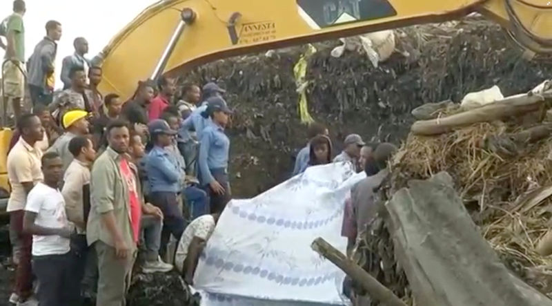 © Reuters. People gather at the site after a landslide at a garbage dump on the outskirts of Addis Ababa, Ethiopia in this still image taken from a video