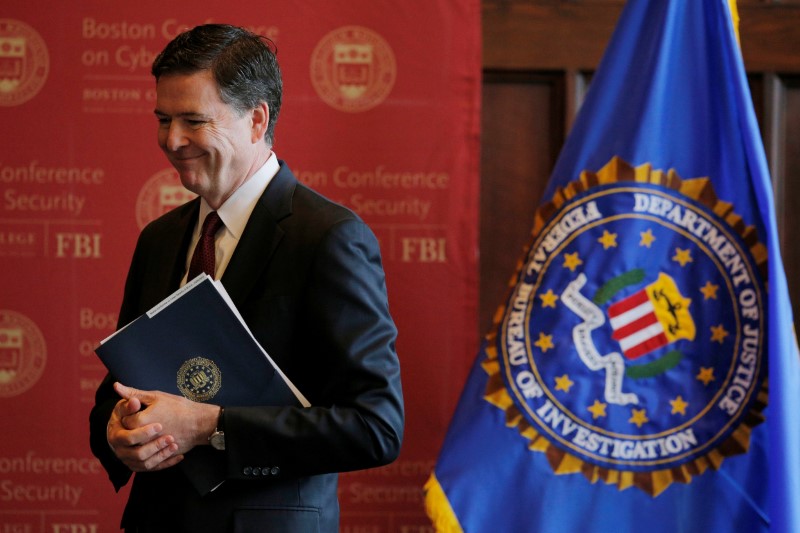 © Reuters. FBI Director James Comey listens as he is thanked for speaking at the Boston Conference on Cyber Security at Boston College in Boston