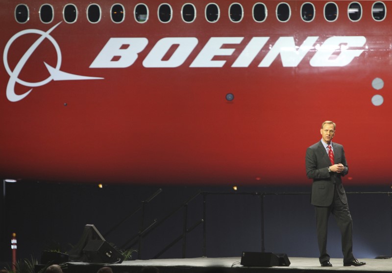 © Reuters. Pat Shanahan speaks, as a curtain is raised to unveil the 747-8 jumbo passenger at the company's Everett, Washington commercial airplane manufacturing facility