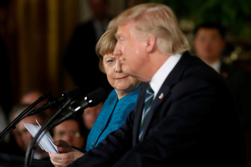 © Reuters. Merkel gives Trump a look during their joint news conference in the East Room of the White House in Washington