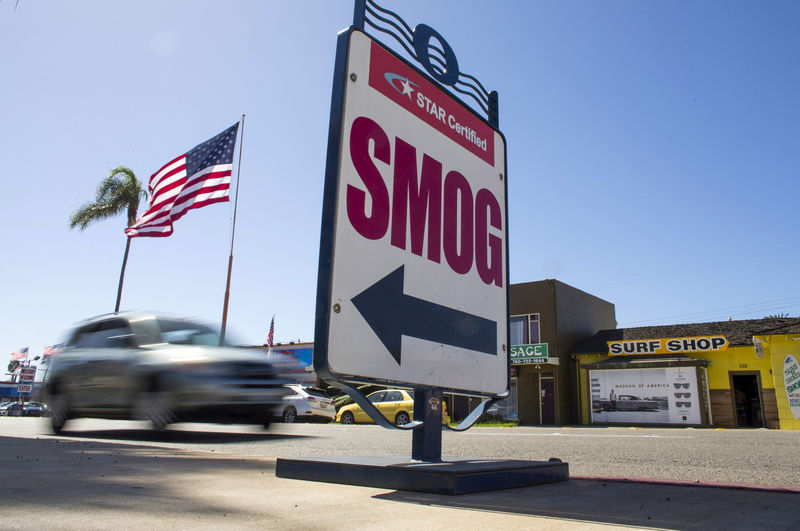 © Reuters. FILE PHOTO: Cars drive past a California emissions testing site in Oceanside