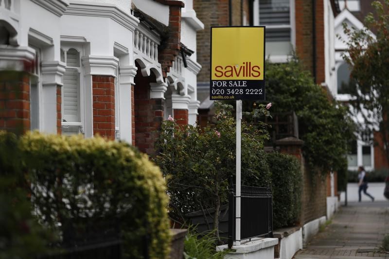 © Reuters. A Savills property estate agent sign is displayed outside a home in south London