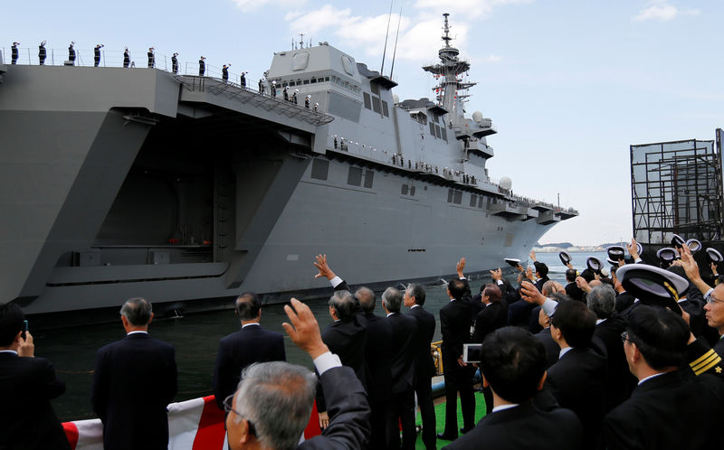 © Reuters. Officials of Defense Ministry see off JMSDF's latest Izumo-class helicopter carrier DDH-184 Kaga after a handover ceremony for the JMSDF by Japan Marine United Corporation in Yokohama