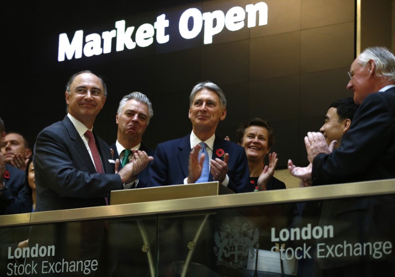 © Reuters. Britain's Chancellor of the Exchequer Philip Hammond (3rd L), opens the London Stock Exchange