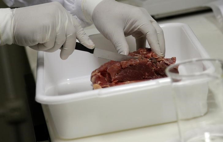 © Reuters. A veterinarian analyzes a piece of meat collected by Public Health Surveillance agents during an inspection of supermarkets, at a veterinary laboratory with the public health department in Rio de Janeiro