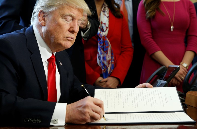 © Reuters. Trump signs an executive order at the White House in Washington